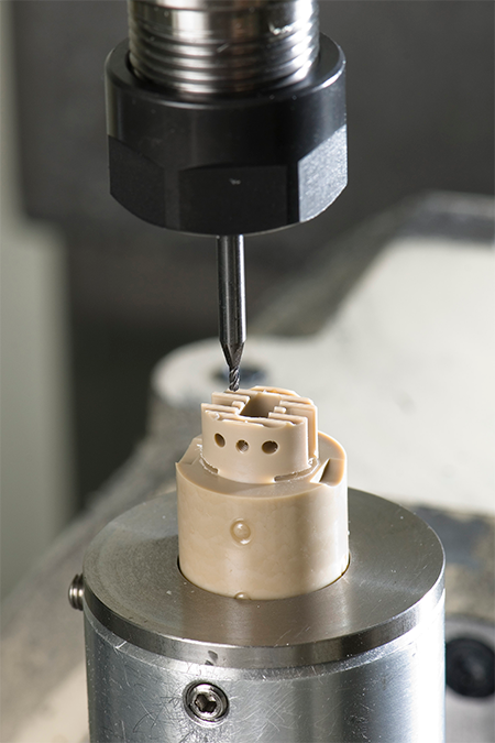 One of a family of spinal fusion cages nearing completion of the first setup on a 5-axis CNC.